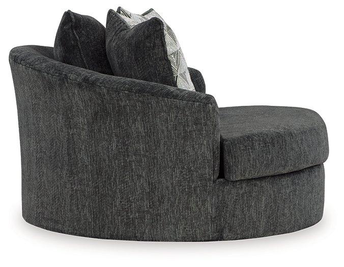 Ashley Furniture Biddeford oversized swivel accent chair with plush fabric and wide armrests, shown in a cozy, modern living room setting.