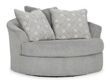 Ashley Furniture Casselbury oversized swivel accent chair with plush fabric and modern design, shown in a stylish living room setting.