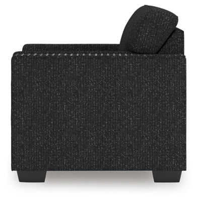 Ashley Furniture Jasmine Peaks Chair showing side view with plush fabric upholstery and wooden legs.