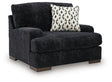 Ashley Furniture Whitmore Manor oversized chair with plush upholstery and wide armrests, shown from an angled side view.