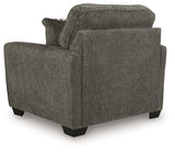 Ashley Furniture Olten oversized chair with plush fabric, wide armrests, and a comfortable backrest in a modern living room setting.