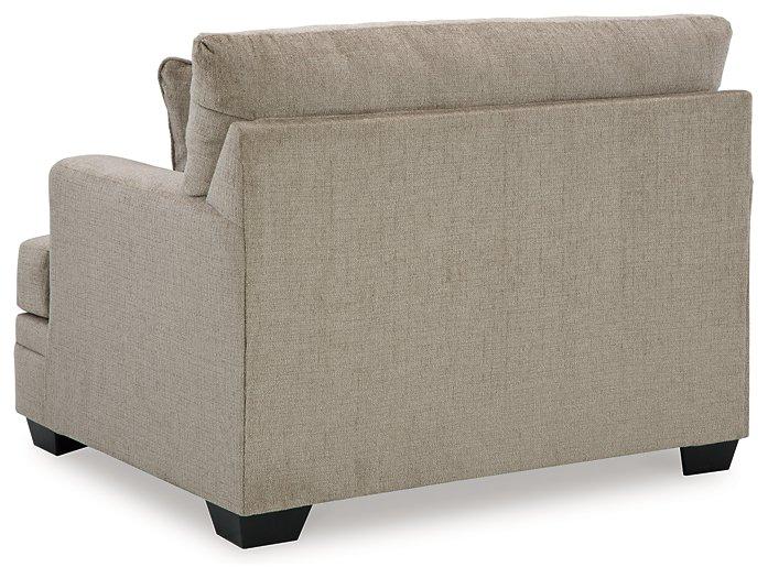 Ashley Furniture Stonemeade oversized chair with plush fabric, wide seating, and cushioned armrests in a cozy living room setting.