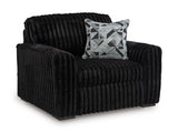 Ashley Furniture Midnight-Madness oversized chair with plush fabric and wide seating, shown from an angled view.