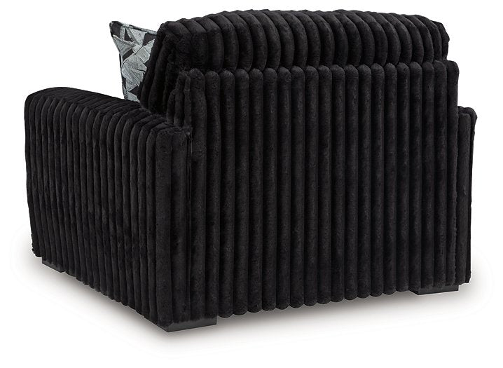 Ashley Furniture Midnight-Madness oversized chair with plush fabric and wide armrests, shown from the back.