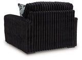Ashley Furniture Midnight-Madness oversized chair with plush fabric and wide armrests, shown from the back.