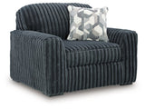 Ashley Furniture Midnight Madness oversized chair with plush fabric and wide armrests, shown from an angled side view.