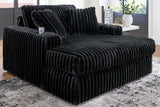 Oversized Midnight-Madness Ashley Furniture chaise lounge with plush fabric and modern design, perfect for relaxing in style.