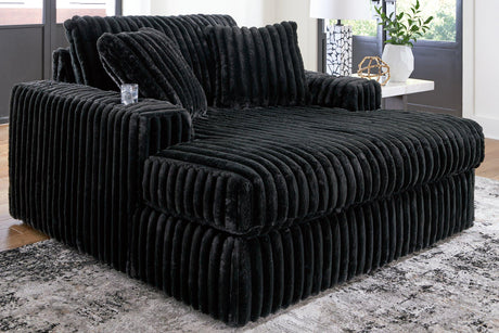 Oversized Midnight-Madness Ashley Furniture chaise lounge with plush fabric and modern design, perfect for relaxing in style.