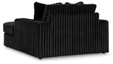 Oversized Ashley Furniture Midnight-Madness chaise lounge with plush fabric and wide seating for relaxing comfort.