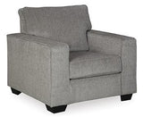 Ashley Furniture Altari chair with plush upholstery and wooden legs, shown in a cozy living room setting.