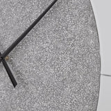 Ashley Furniture Reinport wall clock with a sleek round design and modern numerals, hanging on a neutral-toned wall.