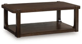 Ashley Furniture Breckington coffee table with a dark wood finish, shown from an angled side view.