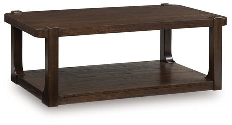 Ashley Furniture Breckington coffee table with a dark wood finish, shown from an angled side view.