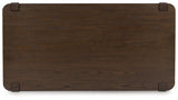 Breckington Ashley Furniture cocktail coffee table with a wooden top and dark metal legs, modern design, close-up view.