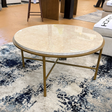 Ashley Furniture Alder coffee table with a sleek design, featuring a smooth wooden surface and modern style for living rooms.