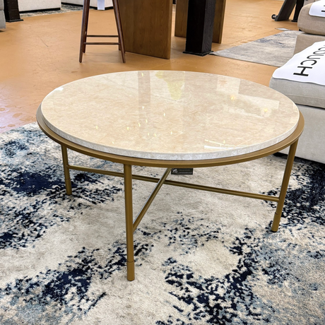 Ashley Furniture Alder coffee table with a sleek design, featuring a smooth wooden surface and modern style for living rooms.