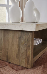 Ashley Furniture Brendalhouse cocktail coffee table with a wooden finish and modern design, shown in a stylish living room setting.