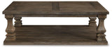 Ashley Johnelle coffee table, modern cocktail table with wood finish and sleek design, ideal for living room decor.