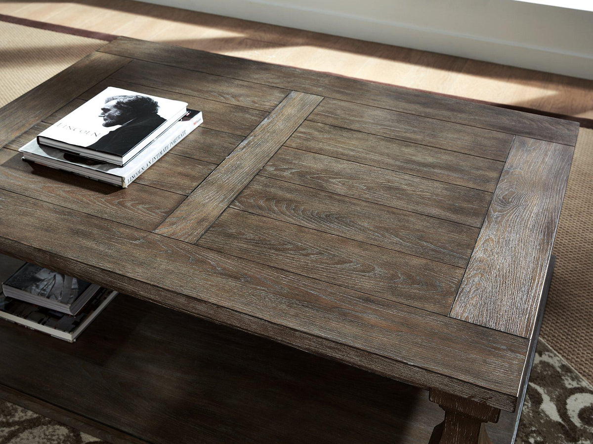 Ashley Furniture Johnelle coffee cocktail table with a sleek wooden surface and modern design, ideal for living room decor.