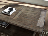 Ashley Furniture Johnelle coffee cocktail table with a sleek wooden surface and modern design, ideal for living room decor.