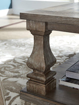 Ashley Johnelle coffee table, modern cocktail table with a sleek wooden finish, perfect for living room décor.