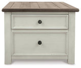 Ashley Furniture Bolanburg coffee table with lift top, showing the wooden surface and modern design in a living room setting.