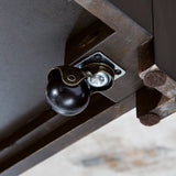 Ashley Furniture Drazmine lift-top coffee table with a sleek cocktail design and caster wheels for easy mobility.