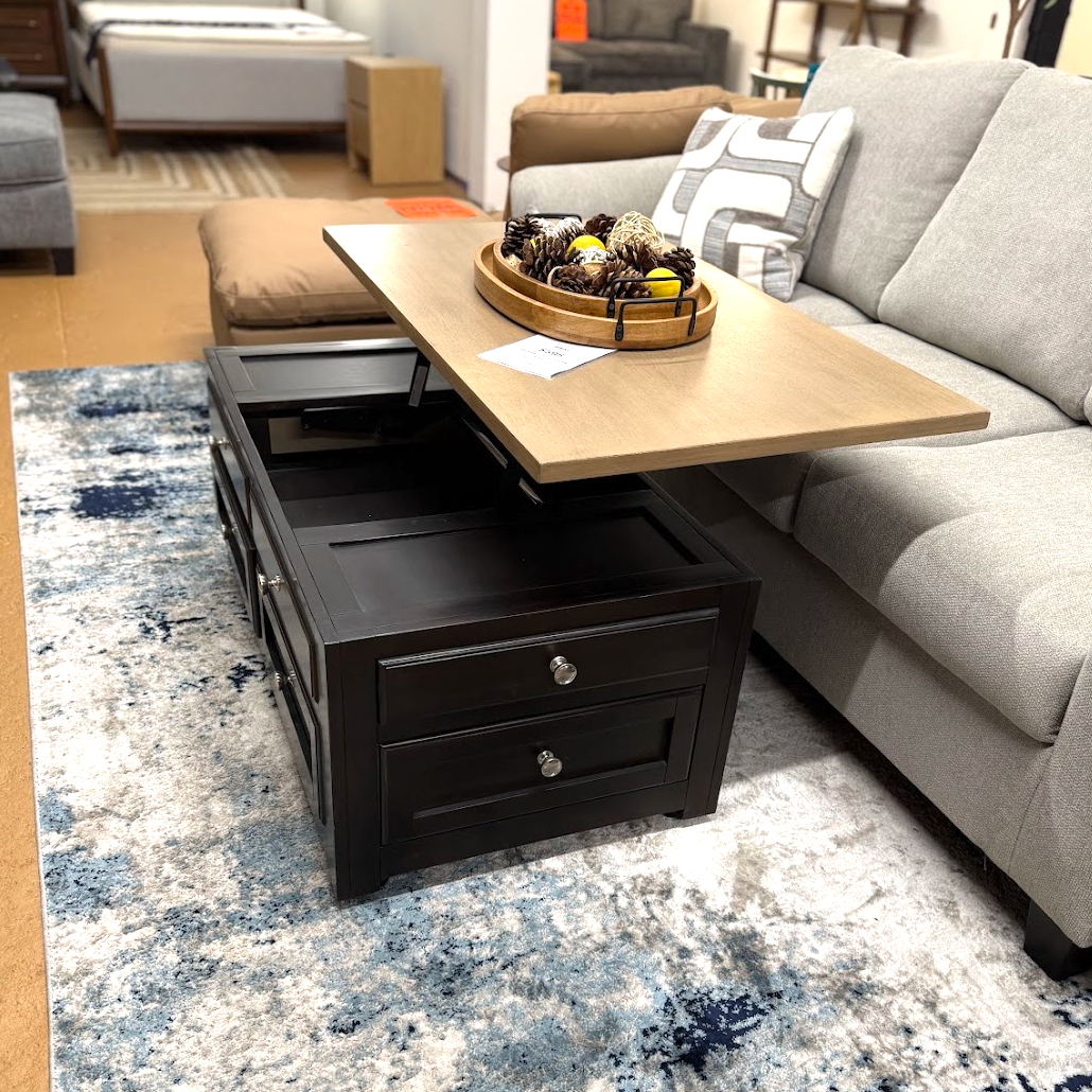 Ashley Furniture Drazmine lift-top coffee table with a wooden finish and spacious storage compartment.