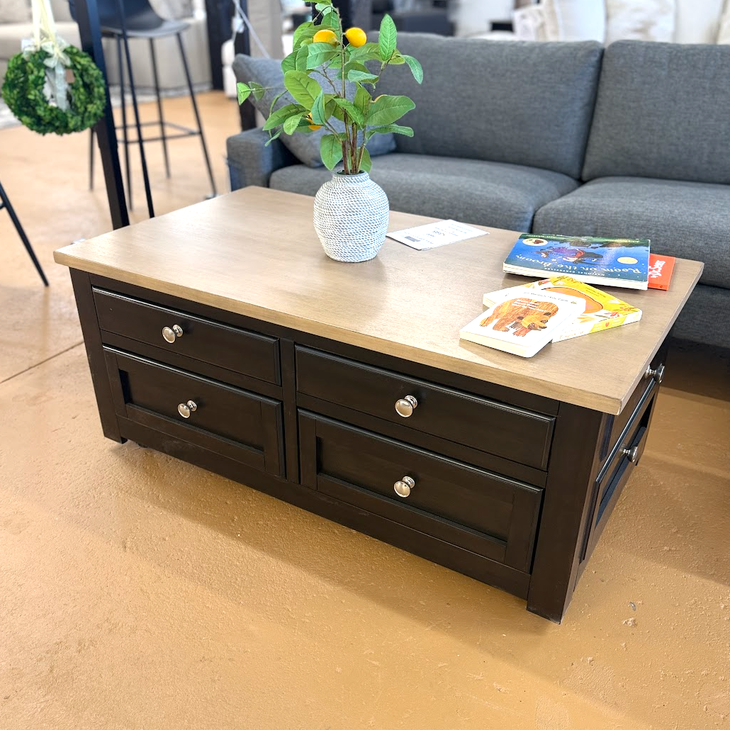 Ashley Furniture Drazmine lift-top coffee table with a sleek wooden finish and a functional lifting top for versatile use.