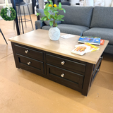 Ashley Furniture Drazmine lift-top coffee table with a sleek wooden finish and a functional lifting top for versatile use.