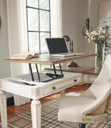 Ashley Furniture Realyn 2-piece home office lift top desk with wood finish and spacious work surface, perfect for workspace organization.