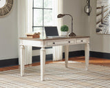 Ashley Furniture Realyn Home Office Lift Top Desk showing a sleek wooden desk with a lift-up top and storage compartments.