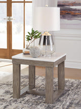 Ashley Furniture Loyaska End Table with wooden surface and modern design, perfect for living room or bedroom decor.