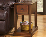 Ashley Furniture Breegin chairside end table with a wood finish, featuring a spacious top and storage shelf in a contemporary design.