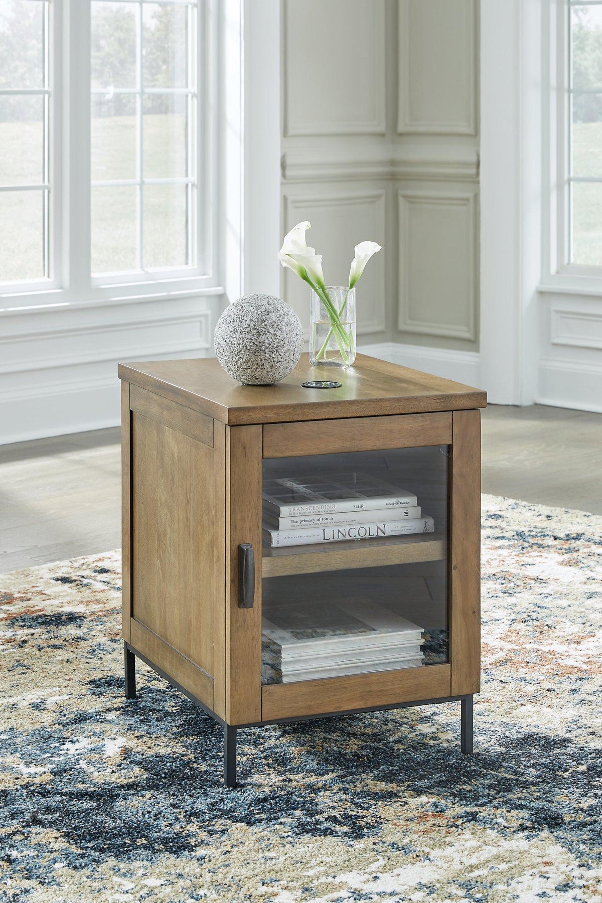 Ashley Furniture Torlanta chairside end table with a wooden surface and sleek design, perfect for small living spaces.