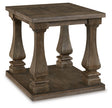 Ashley Furniture Johnelle End Table with a wood finish, featuring a sleek surface and modern design, shown from an angled view.