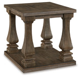 Ashley Furniture Johnelle End Table with a wood finish, featuring a sleek surface and modern design, shown from an angled view.