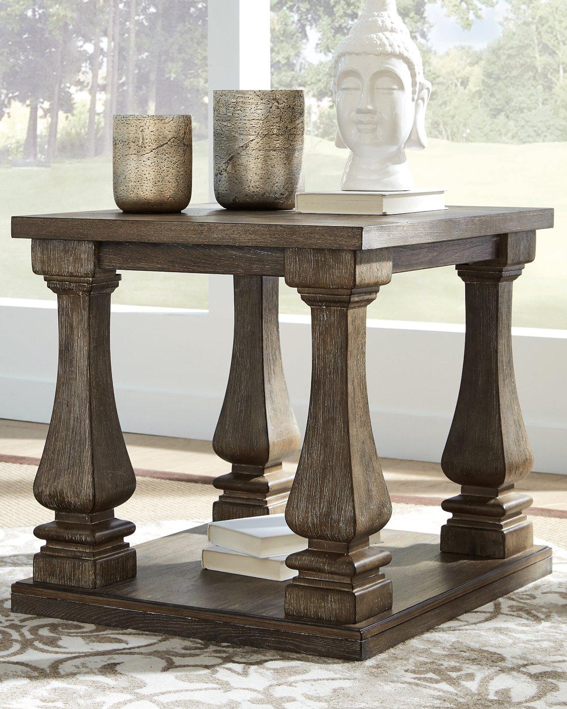 Johnelle end table by Ashley Furniture with a wooden finish and modern design, showing the tabletop and sturdy legs.