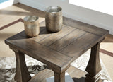 Ashley Furniture Johnelle End Table with a wooden top and modern design, featuring a sleek surface and sturdy legs.