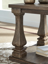 Close-up of the Johnelle Ashley Furniture end table showing its detailed wood finish and elegant design.