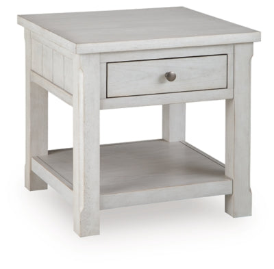 Ashley Furniture Robbinsdale end table with a closed drawer, wood finish, and classic design, shown from an angled side view.