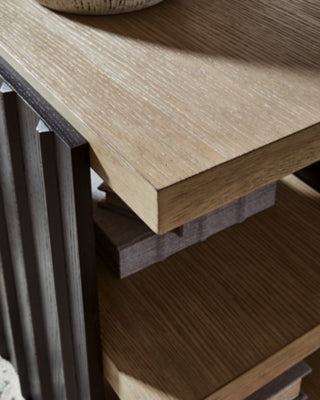 Close-up of Ashley Furniture Rylandyn end table showcasing its detailed wood finish and elegant design.