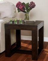 Ashley Furniture Watson End Table with a sleek wooden finish and modern design, perfect for living room décor.