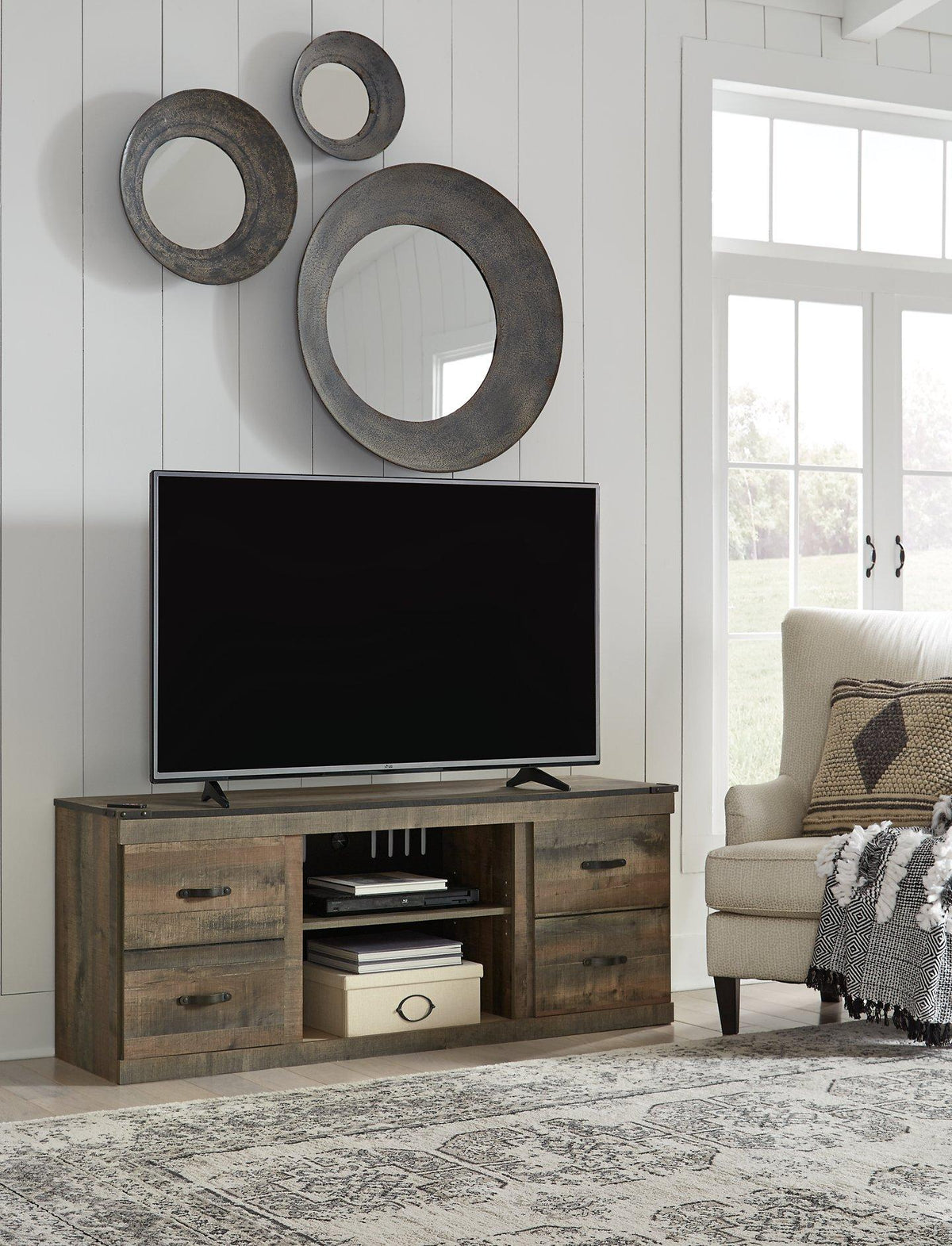 Ashley Trinell 3-piece entertainment center with electric fireplace, featuring wood finish, storage cabinets, and a built-in fireplace unit.