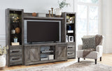 Wynnlow 4-piece entertainment center by Ashley Furniture featuring modern wood finish and multiple storage compartments.