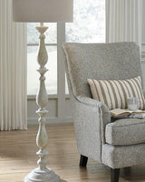 Bernadate Floor Lamp by Ashley Furniture with a tall, elegant design and a fabric lampshade for living room lighting.