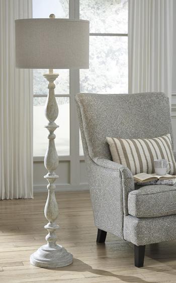 Bernadate floor lamp by Ashley Furniture featuring a sleek modern design with a tall metal stand and a fabric lampshade.
