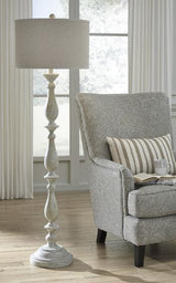 Bernadate floor lamp by Ashley Furniture featuring a sleek modern design with a tall metal stand and a fabric lampshade.