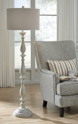 Modern Bernadate Floor Lamp by Ashley Furniture featuring a sleek design with a tall metal stand and fabric lampshade.
