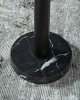 Close-up of the base of the Sorcha floor lamp by Ashley Furniture, showcasing its elegant design and sturdy construction.